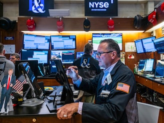 Traders work on the floor of the New York Stock Exchange (NYSE) on July 23, 2025, in New York City. The Dow rose over 500 points Wednesday as investors reacted to an announcement that Donald Trump has reached a trade deal with Japan.