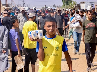 A Palestinian youth shows bags of flour he received at the Rafah corridor as he walks in the Mawasi area of Rafah in the southern Gaza Strip on July 28, 2025.
Image: AFP