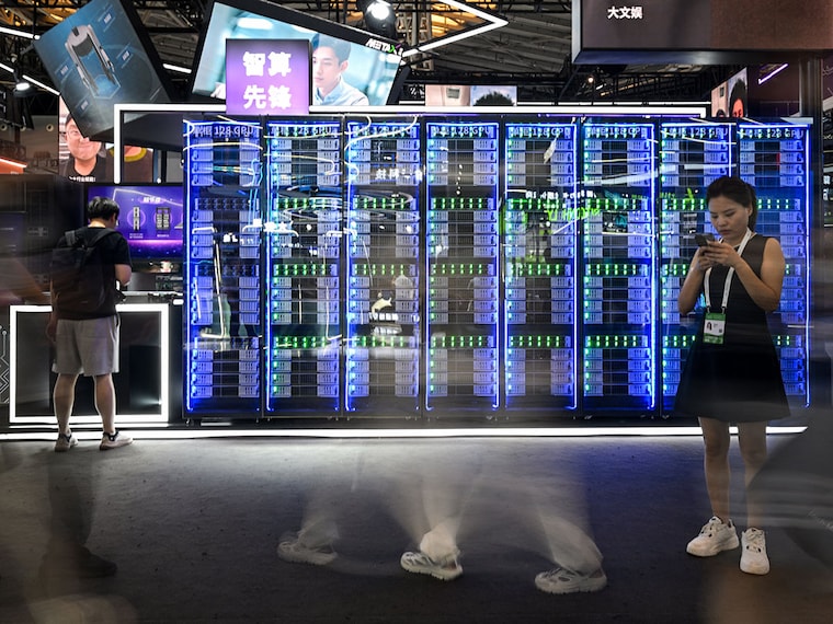 A long exposure shows people visiting the World Artificial Intelligence Conference (WAIC) at the Shanghai World Expo and Convention Center in Shanghai on July 28, 2025.
Image: Hector Retamal / AFP