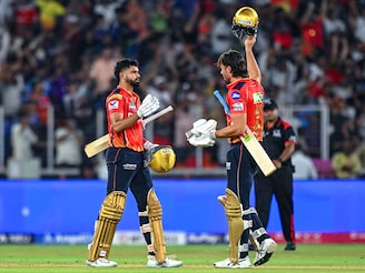 Punjab Kings" captain Shreyas Iyer (L) and his teammate Marcus Stoinis celebrate their team"s win in the Indian Premier League (IPL) Twenty20 second qualifier cricket match between Punjab Kings and Mumbai Indians at the Narendra Modi Stadium in Ahmedabad on June 2, 2025.