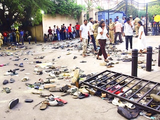 Fans stand next to abandonned shoes and a fallen barrier following a stampede during celebrations, a day after Royal Challengers Bengaluru"s victory at the Indian Premier League (IPL) Twenty20 final cricket match, outside the M. Chinnaswamy Stadium in Bengaluru on June 4, 2025. At least 11 people were killed in a stampede on June 4, as a tightly packed crowd celebrated the victory of their home cricket team in the Indian city of Bengaluru, the state"s chief minister said. Image:  AFP