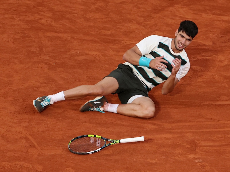 Spain"s Carlos Alcaraz lies on the ground as he celebrates his victory after his men"s singles final match against Italy"s Jannik Sinner on day 15 of the French Open tennis tournament on Court Philippe-Chatrier at the Roland-Garros Complex in Paris on June 8, 2025.