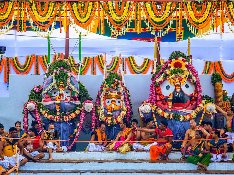 Traditional temple servitors and devotees are seen near the Shree Jagannath Temple as the deities—Lord Balabhadra, Devi Subhadra, and Lord Jagannath—are displayed on the Snana Mandap during the ""Snana Purnima"" festival (bathing rituals) at the Shree Jagannath Temple in Puri, located about 65 km from Bhubaneswar, the capital of the eastern Indian state of Odisha.