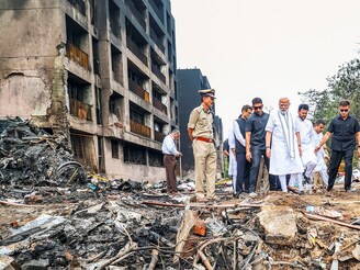 In this image via PMO, Prime Minister Narendra Modi, with Civil Aviation Minister Rammohan Naidu, visits the site of the Air India plane crash in Ahmedabad on Friday, June 13, 2025. A London-bound Air India plane carrying 242 passengers crashed moments after taking off from the Ahmedabad airport on Thursday.