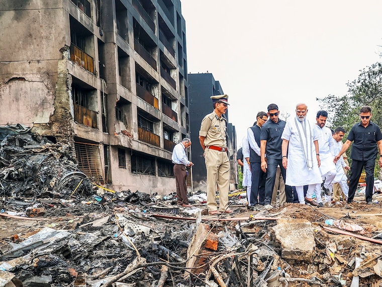 In this image via PMO, Prime Minister Narendra Modi, with Civil Aviation Minister Rammohan Naidu, visits the site of the Air India plane crash in Ahmedabad on Friday, June 13, 2025. A London-bound Air India plane carrying 242 passengers crashed moments after taking off from the Ahmedabad airport on Thursday.