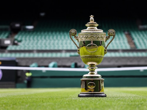 (File) The Gentlemen"s Singles Championship trophy is displayed on the grass of Center Court during Wimbledon Championships at The All England Tennis Club in Wimbledon, southwest London. 
Image: Adrian Dennis / AFP