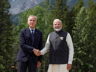 Canadian Prime Minister Mark Carney and India"s Prime Minister Narendra Modi pose for a photo during the G7 Leaders" Summit in Kananaskis, in Alberta, Canada, June 17, 2025.
