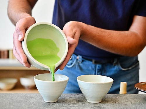 (File) A employee at Kettl Tea in the Los Feliz neighborhood of Los Angeles, California prepares a matcha beverage. The word matcha means "ground tea" in Japanese, and comes in the form of a vivid green powder that is whisked with hot water and can be added to milk to make a matcha latte. (Photo by Frederic J. Brown / AFP
