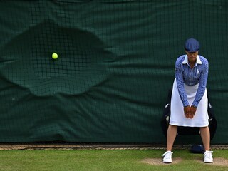 (FILES) A line judge stands in position as a ball hits the back netting after a serve during the men"s doubles semi-final tennis match on the eleventh day of the 2024 Wimbledon Championships at The All England Lawn Tennis and Croquet Club in Wimbledon, southwest London.
Image: An drej Isakovic / AFP