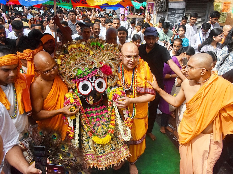 ISKCON monks carry the idol of Lord Jagannath to his rath during the annual Rathayatra celebration in Kolkata, India, on June 27, 2022. Rathayatra is an annual festival celebrating the arrival of Gods Jagannath, Subhadra, and Balaram to their aunt"s place at Gundicha temple in Puri, Odisha.