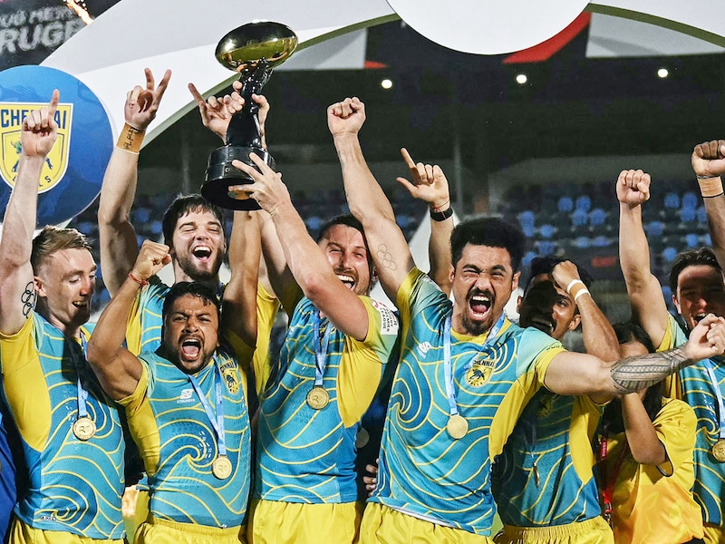 Chennai Bulls" players celebrate with the trophy after winning the Indian Rugby Premier League (RPL) final rugby match between Chennai Bulls and Delhi Redz at the Andheri Sports Complex in Mumbai on June 29, 2025.
