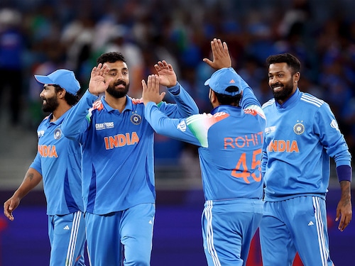 Spinner Varun Chakravarthy celebrates with skipper Rohit Sharma and teammates Hardik Pandya and Ravindra Jadeja after taking the wicket of Matt Henry of New Zealand (not pictured) during the ICC Champions Trophy 2025 match between New Zealand and India at Dubai International Cricket Stadium on March 02, 2025, in Dubai, United Arab Emirates. Chakravarthy took 5 wickets, and India won by 44 runs to play with Australia in the semi-finals of the Champions Trophy.