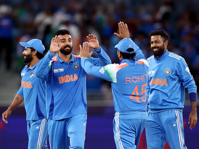 Spinner Varun Chakravarthy celebrates with skipper Rohit Sharma and teammates Hardik Pandya and Ravindra Jadeja after taking the wicket of Matt Henry of New Zealand (not pictured) during the ICC Champions Trophy 2025 match between New Zealand and India at Dubai International Cricket Stadium on March 02, 2025, in Dubai, United Arab Emirates. Chakravarthy took 5 wickets, and India won by 44 runs to play with Australia in the semi-finals of the Champions Trophy.