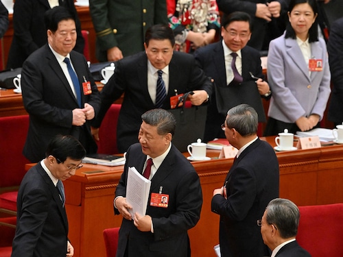 China"s President Xi Jinping (C), Premier Li Qiang (R) and Politburo Standing Committee member Wang Huning (L) leave their seats following the opening session of the National People"s Congress (NPC) at the Great Hall of the People in Beijing on March 5, 2025. 
Image: Adek Berry / AFP