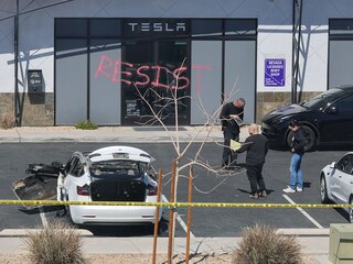 Investigators look over the scene at a Tesla Collision Center after an individual used incendiary devices to set several vehicles on fire and spray painted the word "RESIST" on the entrance on March 18, 2025 in Las Vegas, Nevada.
Image:  Ethan Miller/Getty Images