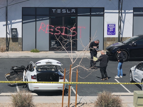 Investigators look over the scene at a Tesla Collision Center after an individual used incendiary devices to set several vehicles on fire and spray painted the word "RESIST" on the entrance on March 18, 2025 in Las Vegas, Nevada.
Image:  Ethan Miller/Getty Images