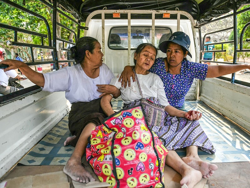 A survivor reacts as she is brought in the back of a lorry to a hospital in Naypyidaw on March 28, 2025, after an earthquake in central Myanmar. On March 28, a powerful earthquake rocked central Myanmar, buckling roads in the capital, Naypyidaw, damaging buildings, and forcing people to flee into the streets in neighbouring Thailand.