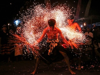 A Balinese man is hit with burnt dried coconut leaves during a firefighting ritual ahead of the holy day of Nyepi, a day of silence and self-reflection to celebrate the Balinese Hindu New Year in Paksebali village, Klungkung, Bali, Indonesia, on March 28, 2025. Image: Johannes P. Christo/ Reuters