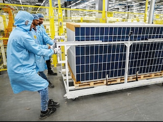 Will 3500 percent US solar tariffs become silver lining for Asian energy transition?
Caption &amp credit: (File) Workers pulling a trolley loaded with solar panels at an Adani Group factory in Mundra.
Image: Punit Paranjpe / AFP