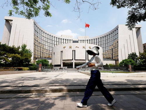 A person walks past the headquarters of the People"s Bank of China, in Beijing, China on May 7, 2025.
Image: Tingshu Wang / Reuters