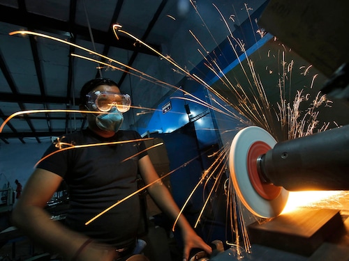 A worker operates a lathe machine as he makes a steel cutter at a manufacturing unit in Noida, on the outskirts of New Delhi.
Image: Reuters/Anindito Mukherjee A worker operates a lathe machine as he makes a steel cutter at a manufacturing unit in Noida, on the outskirts of New Delhi.
Image: Reuters/Anindito Mukherjee