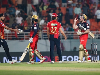 Rajat Patidar (2nd L) and Phil Salt of Royal Challengers Bengaluru (2nd R) celebrate after winning the match during the 2025 IPL Qualifier against Punjab Kings at New PCA Stadium on May 29, 2025, in Chandigarh, India.