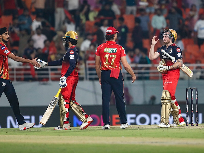 Rajat Patidar (2nd L) and Phil Salt of Royal Challengers Bengaluru (2nd R) celebrate after winning the match during the 2025 IPL Qualifier against Punjab Kings at New PCA Stadium on May 29, 2025, in Chandigarh, India.