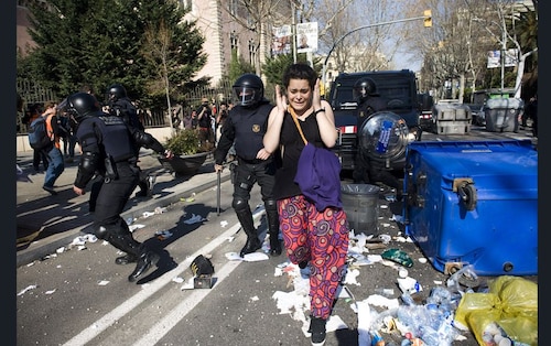  A student runs for cover as riot police try to quash a demonstration in Barcelona, Spain. Student associations had called upon 120,000 pupils to strike in protest against education cuts recently announced by the Catalan government&nbsp