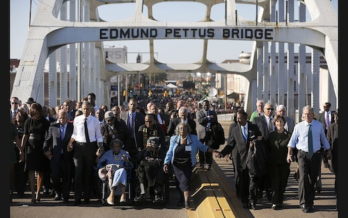  US President Barack Obama (third from left) and wife Michelle participate in a march across the Edmund Pettus Bridge in Selma, Alabama, on March 7. The event comes on the 50th anniversary of the &#39Bloody Sunday&#39 march at the bridge, where police and state troopers beat and used tear gas against peaceful marchers who were advocating against racial discrimination at the voting booth. Also seen are US Representative John Lewis (D-GA) (second from left), former first lady Laura Bush (second from right) and former president George W Bush (extreme right)&nbsp                        