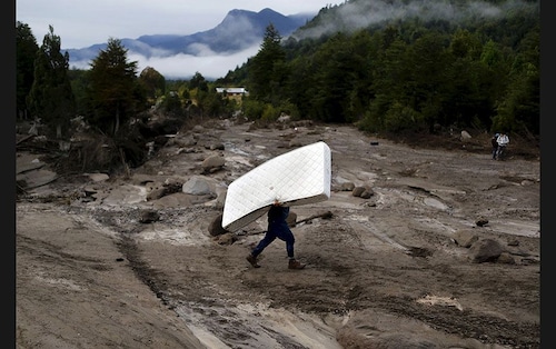  A resident carries a mattress through an area damaged by lahar (hot or cold mixture of water and rock fragments flowing down the slopes of a volcano) from the Calbuco volcano at Correntoso near Chamiza in Chile. Ash from the volcano, which first erupted on April 22 without warning, reached as far as southern Brazil and prompted some airlines to cancel flights to the capital cities of Chile, Argentina and Uruguay                        