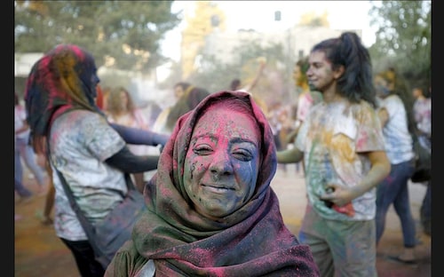  A Palestinian reveller takes part in a festival of colours in the West Bank city of Ramallah on August 20. The festival is inspired by Holi <br /><br />                        