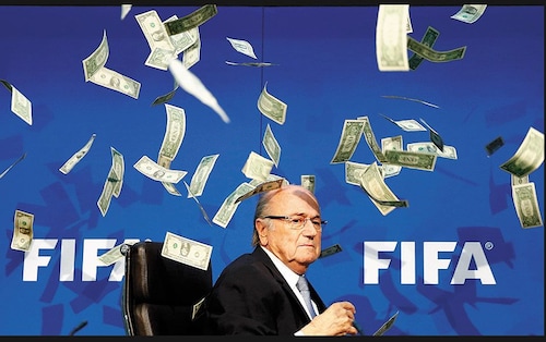  Currency notes are thrown at FIFA President Sepp Blatter as he arrives for a news conference on July 20. Blatter has been banned from football for eight years by the FIFA Ethics Committee for making an illicit payment of $2 million to UEFA, the head of the governing body of European football                                                