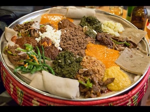  <strong>Ethiopia:</strong> A traditional Ethiopian meal is inherently social and shared communally from a platter. You would see an Ethiopian family gathered around a table and scooping up curries with an injera (a staple flatbread made of teff flour that also doubles up as cutlery for the uninitiated). This family-style serving also makes it difficult to control portions.                                                