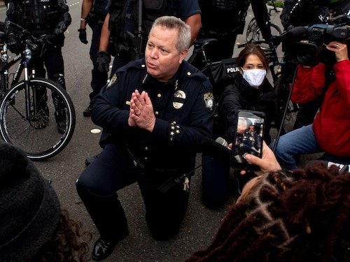  <p>BELLEVUE, WA - MAY 31: Bellevue Police Chief Steve Mylett kneels next to demonstrators during a gathering to protest the recent death of George Floyd on May 31, 2020 in Bellevue, Washington. Protests took place in Bellevue in addition to Seattle, with looting in Bellevue and at least one burned automobile there</p>
