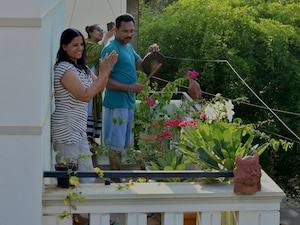  <p>BENGALURU: People gather in a balcony to clap and make noise to thank essential service providers during a one-day Janata (civil) curfew imposed amid concerns over the spread of the COVID-19 novel coronavirus</p>