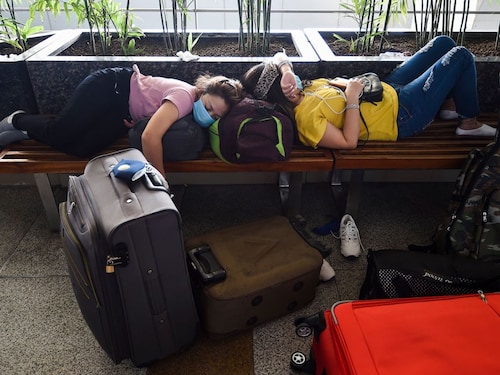  <p><span>Passengers camp out on a bench outside the Indira Gandhi International Airport in Delhi on the first day of resuming of domestic flights after the government imposed a nationwide lockdown as a preventive measure against the spread of Covid-19 on May 25, 2020</span></p>