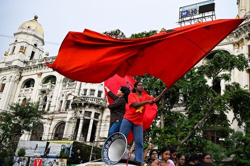  <p>Activists shout slogans and wave flags during a protest rally to condemn the rape and murder of a trainee doctor in RG Kar Medical College in Kolkata, West Bengal, on August 25, 2024. Protests intensified in Kolkata as various groups continued to take to the streets, demanding justice.</p>
