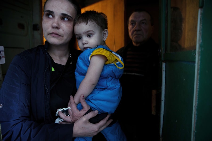 
Residents examine the damage to their apartment building following a night of Russian bomb attacks in Kharkiv, Ukraine, on Friday, April 8, 2022. (Tyler Hicks/The New York Times)
