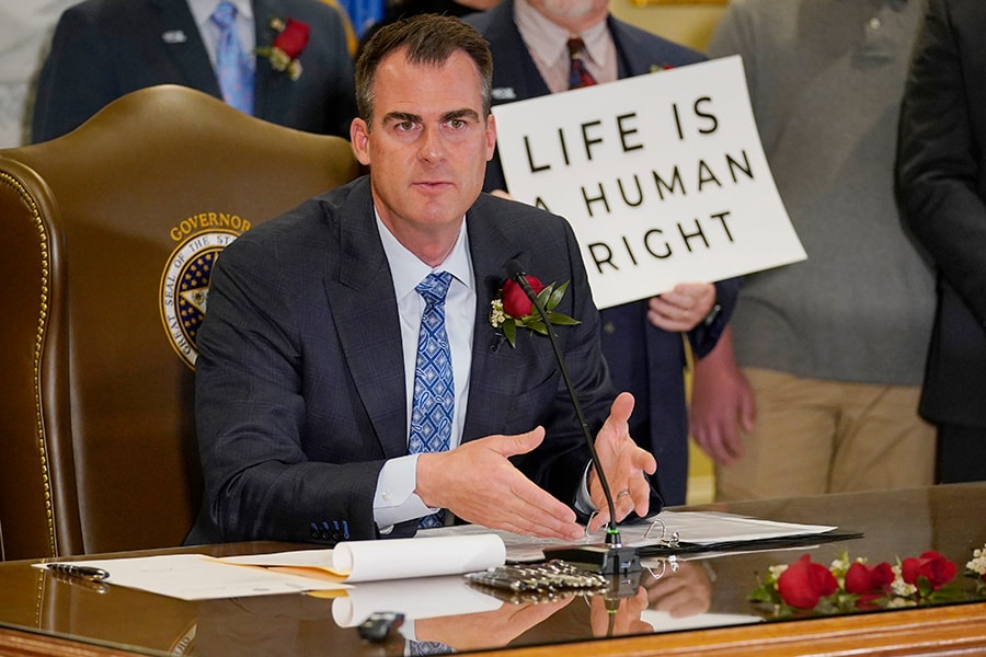 Oklahoma Gov. Kevin Stitt speaks after signing into law a bill making it a felony to perform an abortion, punishable by up to 10 years in prison, Tuesday, April 12, 2022, in Oklahoma City.
Image: AP Photo/Sue Ogrocki