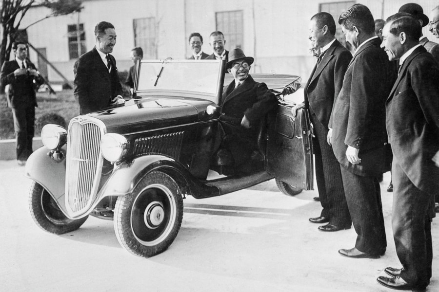 Prince Chichibe, brother to Emperor Hirohito, is shown sitting in a Datsun at the Japanese Industrial Association Plant in Yokohoma, December 1934. Datsun, a car line of the Nissan Company, was one of Japan's most successful mass produced cars. This was Japan's challenge to occidental manufacturers--a tiny automobile to sell for less than the lower priced American cars.
Image: Bettmann / Getty Images