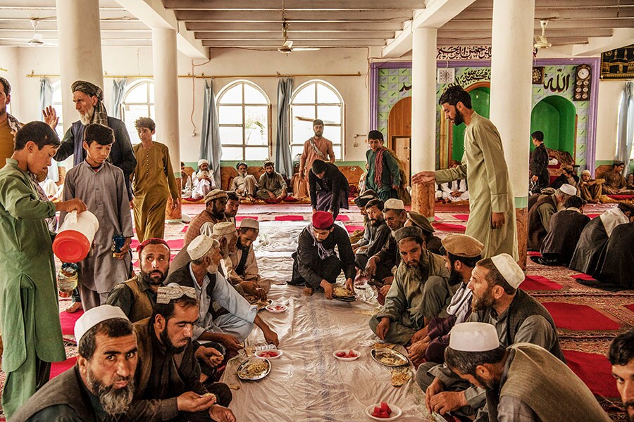 Residents hold a funeral for the four people who died in the flash floods from Tahi Qamar village, in Shinwari, eastern Afghanistan, on Aug. 17, 2022. Widespread flash floods have left more than 40 dead and 100 others injured in recent days in Afghanistan, battering a country already reeling from an economic crisis, terrorist attacks and other natural disasters. (Kiana Hayeri/The New York Times)