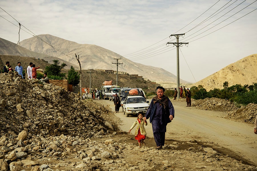 Travelers stranded by road closures caused by the floods wait for the authorities to clear the roads, in Shinwari, eastern Afghanistan, on Aug. 17, 2022. Widespread flash floods have left more than 40 dead and 100 others injured in recent days in Afghanistan, battering a country already reeling from an economic crisis, terrorist attacks and other natural disasters. (Kiana Hayeri/The New York Times)