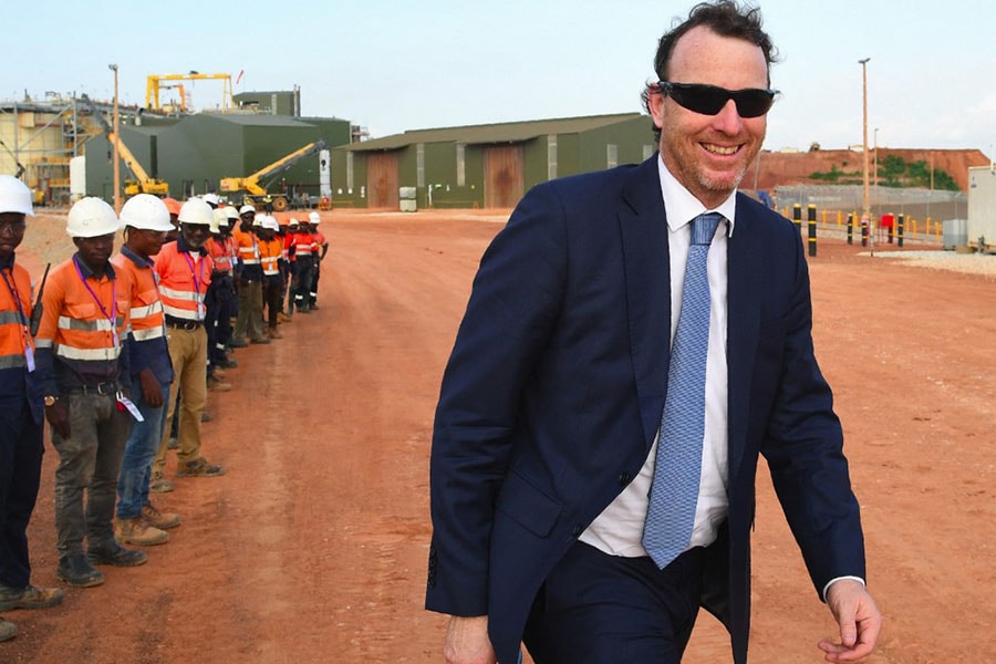 A file photo of Sebastien de Montessus, head of mining group Endeavour walking past workers during the inauguration of the Ity Gold Mine on May 9, 2019 in Danane, western Ivory Coast. The highest-paid CEO on the London index of leading companies in 2021 was Sebastien de Montessus with £16.85 million. Image: ISSOUF SANOGO / AFP

