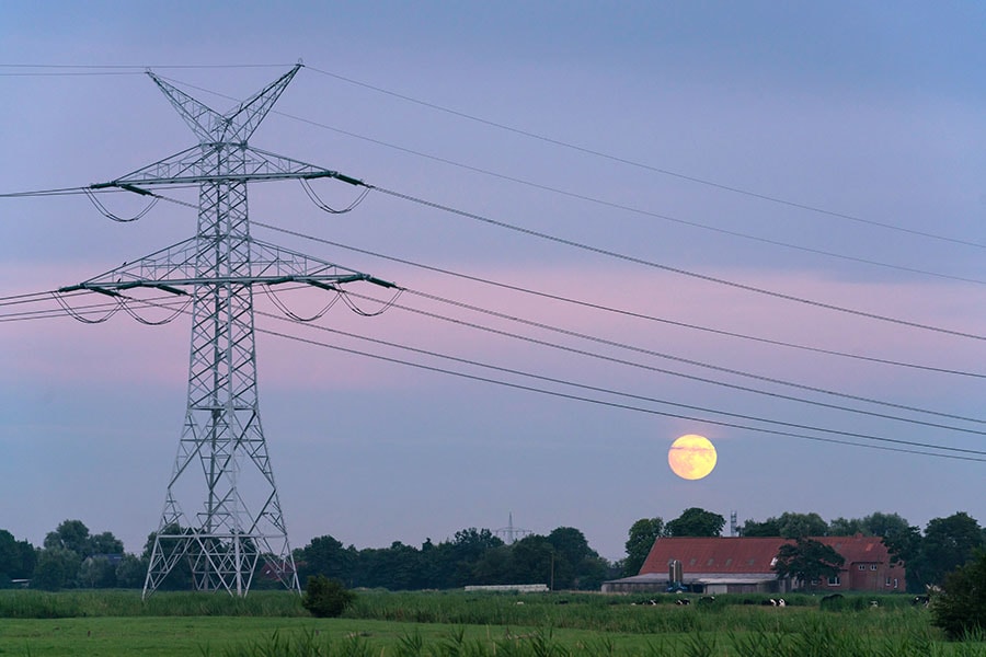 High voltage power lines in Wilhelmshaven, Germany, July 12, 2022. Facilities are being constructed there to receive shipments of liquefied natural gas. (Patrick Junker/The New York Times)