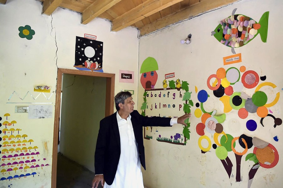 In this picture taken on June 9, 2022, local resident Javed Rahi shows damages in his home caused by a lake outburst because of a melting glacier, in Hassanabad village of Pakistan's Gilgit-Baltistan region. Image: Abdul MAJEED / AFP