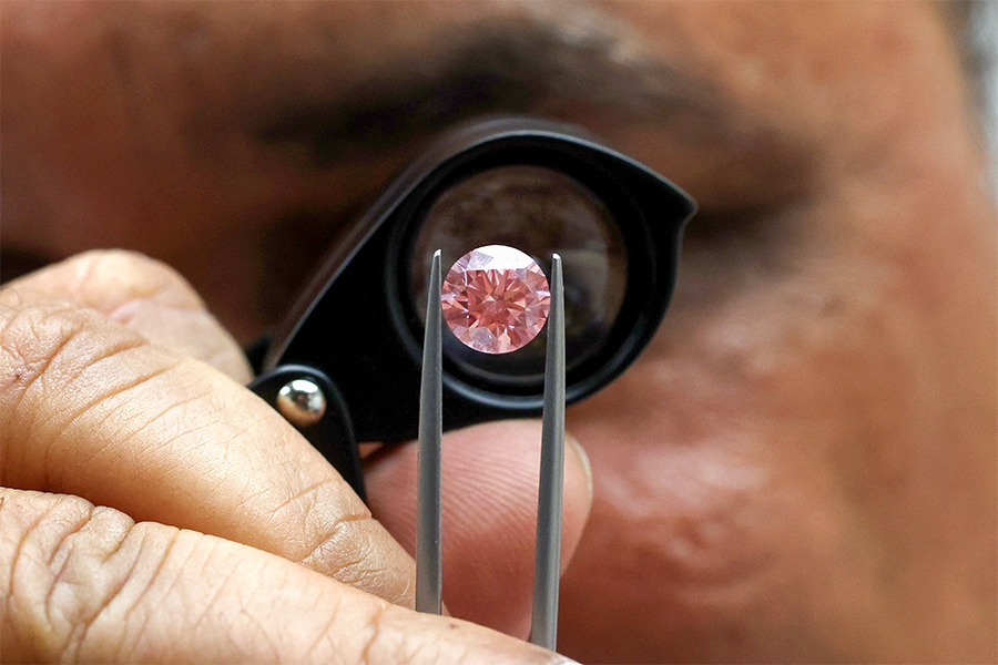 Pravin Kukadia, Director of Eminent Gems LTD, displays a diamond at the Israel World Diamond Center.