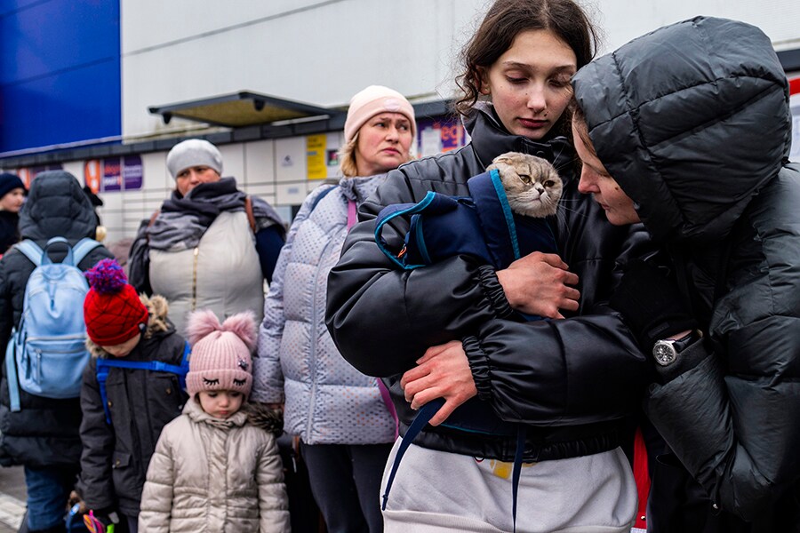 Sofia and Svetlana Klimienko, who fled the fighting in Kharkiv, Ukraine, huddle with their car Amelie after arriving in Przemysl, Poland, on Monday, March 7, 2022. Kharkiv is close to the border with Russia, and as one of the first targets of the Russian invading forces, it has come under some of the heaviest bombardment of the war so far.
Image: Maciek Nabrdalik/The New York Times