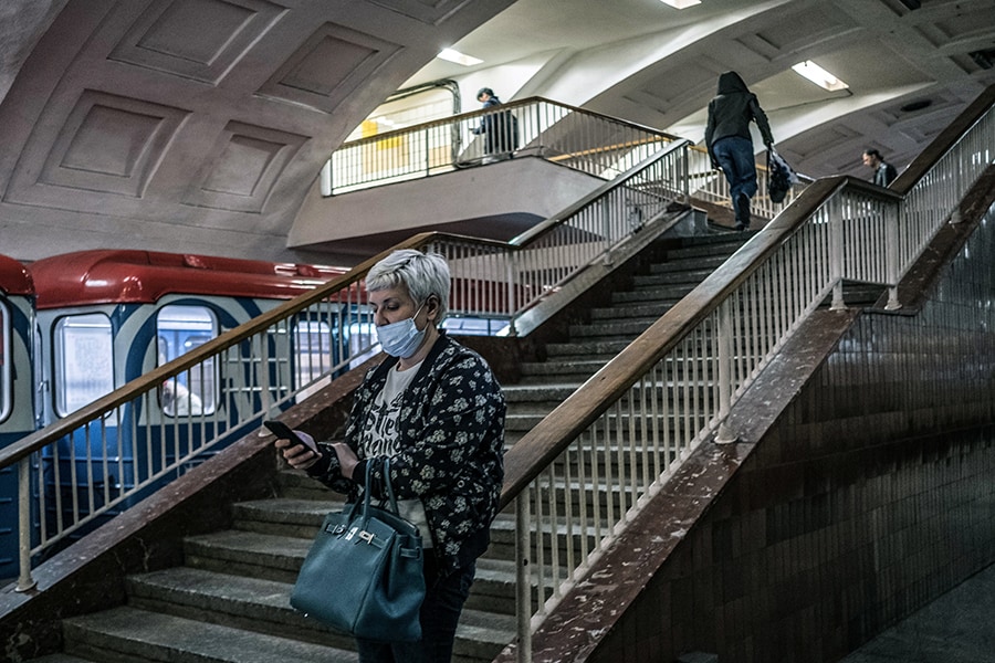 A woman checks her smartphone in a subway station in Moscow on May 7, 2020. The Russian government said Friday, Feb. 25, 2021, it was partially limiting access to Facebook for restricting some pro-Kremlin news media accounts, a move that could make it harder for Russians to share their anger over their country’s invasion of Ukraine. (The New York Times)