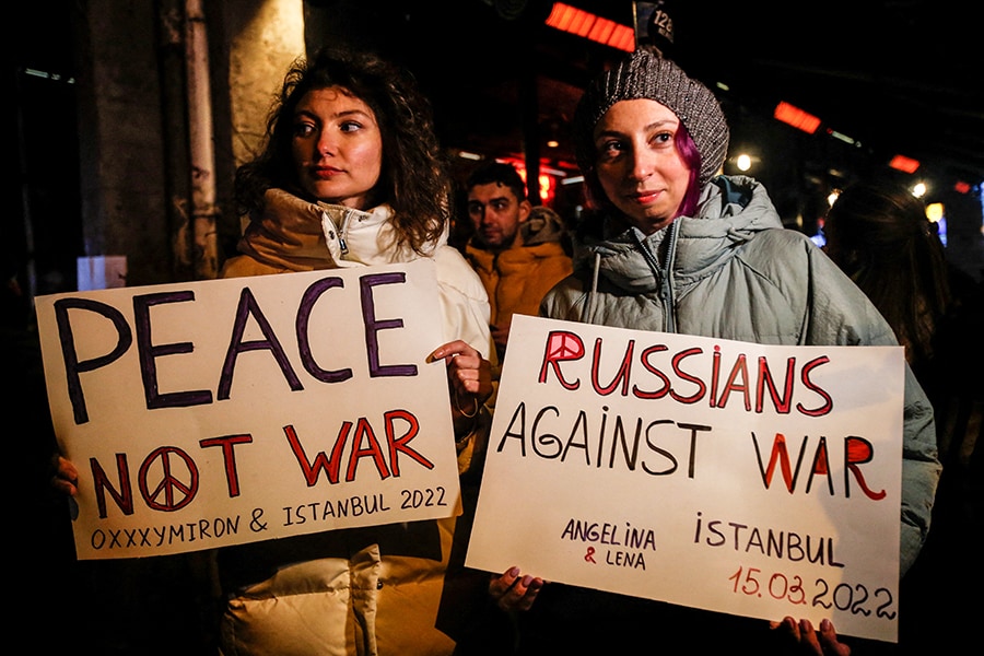 People hold anti-war placards before a rap concert for Ukraine by Russian rapper Oxxxymiron, amid the Russian invasion of Ukraine, in Istanbul, Turkey March 15, 2022. REUTERS/Dilara Senkaya