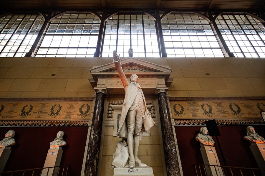 A photograph taken on March 2, 2022 shows the statue ofFrench astronomer, mathematician, freemason, and political leader Jean Sylvain Bailly at the Jeu de Paume hall in Versailles, near Paris. After 8 months of restoration work, the Jeu de Paume room in Versailles, emblematic place of the Revolution in France and symbol of the birth of democracy, is about to reopen its doors to public on April 1, 2022. (Credit: Sameer Al-DOUMY / AFP)